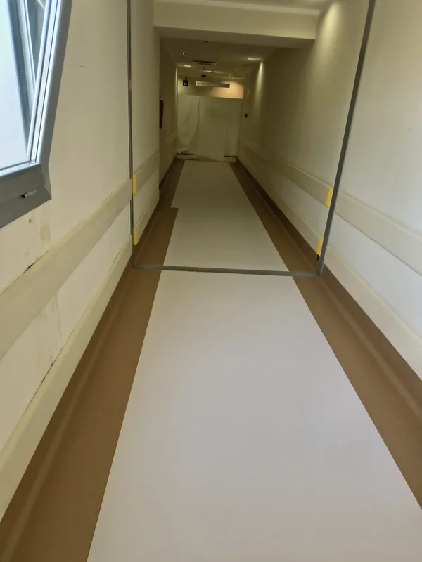 Corridoio con pavimento in PVC chiaro e marrone